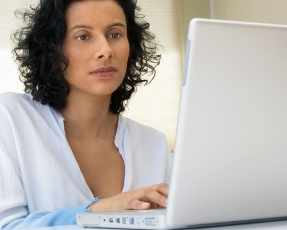 Woman Using Laptop --- Image by © Royalty-Free/Corbis